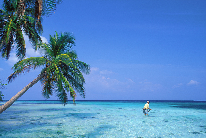 belize-waterfront Belize waterfront — a man fishing on the shallow waters of a Belizean island